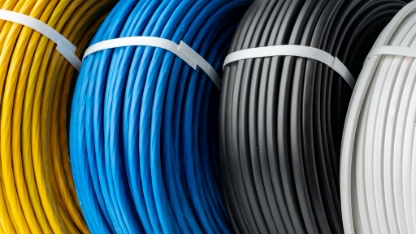 A Close-Up Photo of Four Spools of Electrical Wire, Each Wound in a Different Color.