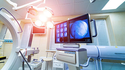 operating room with X-ray medical scan. real modern operating theater with working equipment, lights and computers