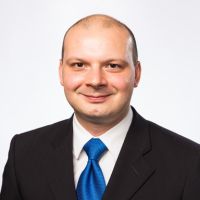 A professional headshot of Carlo Chiavaroli