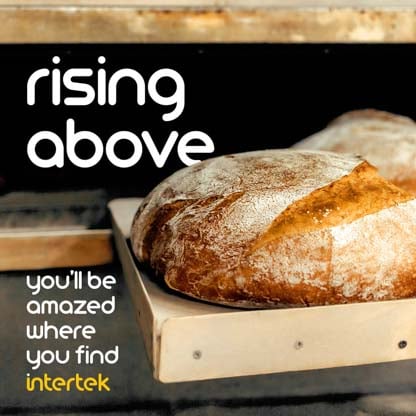 A fresh loaf of bread sitting outside an industrial oven