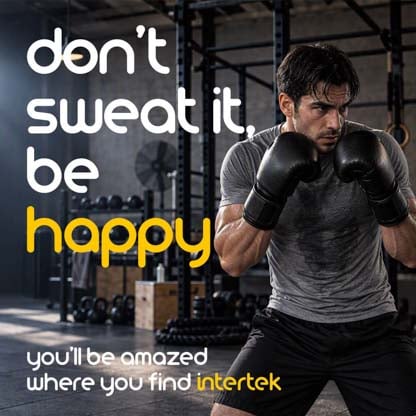A man in a defensive stance while wearing boxing gloves in a gym